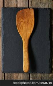Wooden spatula on slate background