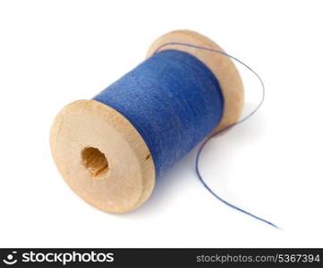 Wooden spool of blue thread isolated on white