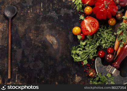 Wooden spoon and ingredients on dark background. Vegetarian food, health or cooking concept.