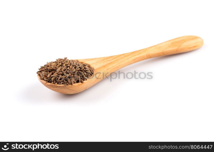 Wooden spoon and pile of cumin seeds isolated on white background