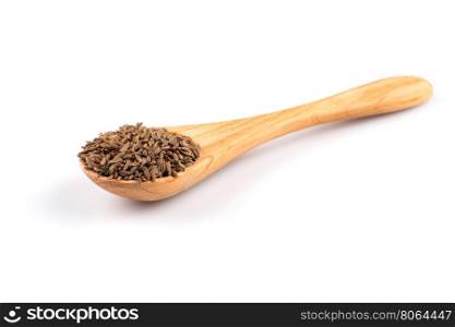 Wooden spoon and pile of cumin seeds isolated on white background