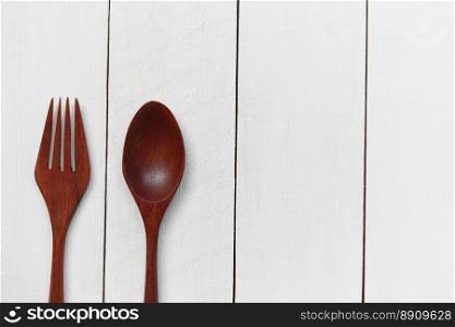 Wooden spoon and wooden fork on white wooden floor.. Wooden spoon and wooden fork on white wooden floor background for design in your work.