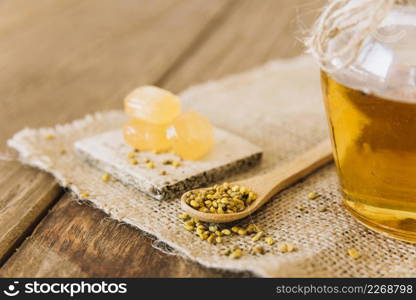 wooden spoon bee pollen seeds candies jar honey sack cloth