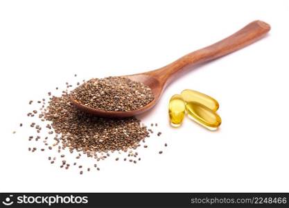 Wooden spoon full of organic natural chia seeds and and omega pills close-up. High quality photo. Wooden spoon full of organic natural chia seeds and and omega pills close-up
