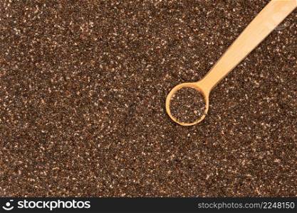 Wooden spoon full of organic natural chia seeds close-up. High quality photo. Wooden spoon full of organic natural chia seeds close-up