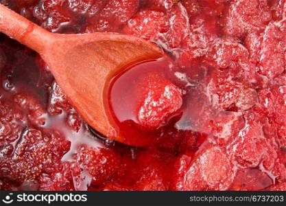 wooden spoon in a home made strawberry jam
