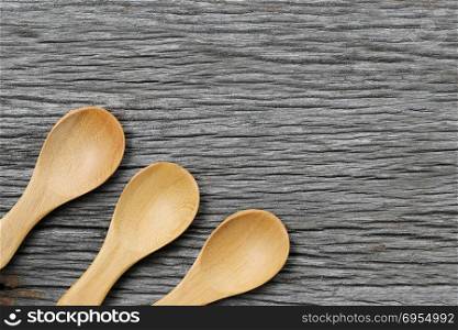 Wooden spoon on brown wood floors,concept of utensils and cooking.