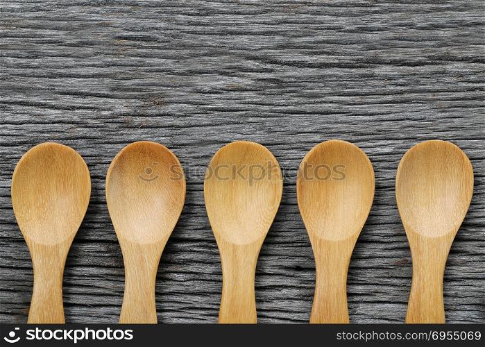 Wooden spoon on brown wood floors,concept of utensils and cooking.