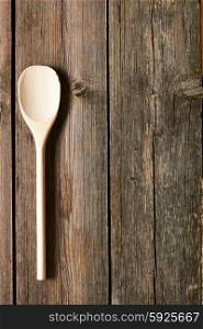 Wooden spoon on rustic background