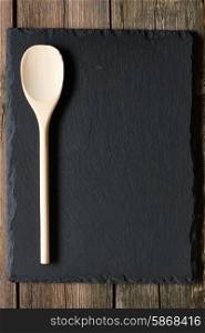Wooden spoon on slate background