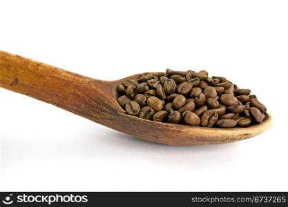wooden spoon with coffee beans on white background