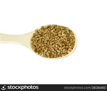 Wooden spoon with lots of buckwheat groats on a white background
