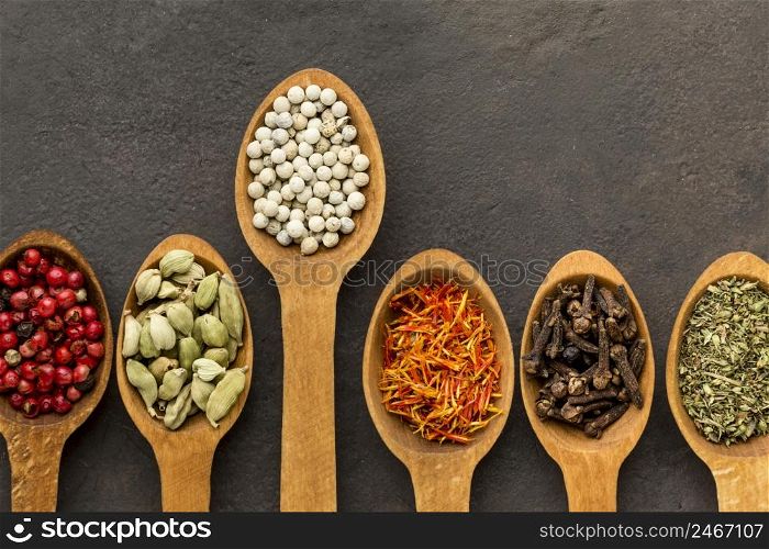 wooden spoon with spices aligned