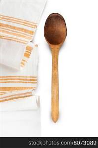 Wooden spoons and homespun towel isolated on white background