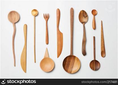 Wooden spoons, knives, forks on a white background. Wooden spoons, knives, forks o