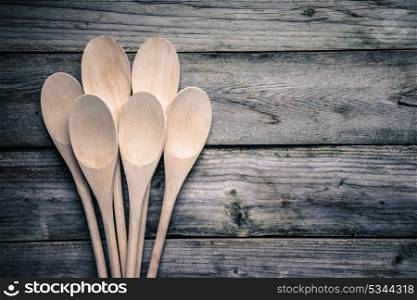 Wooden spoons on rustic background