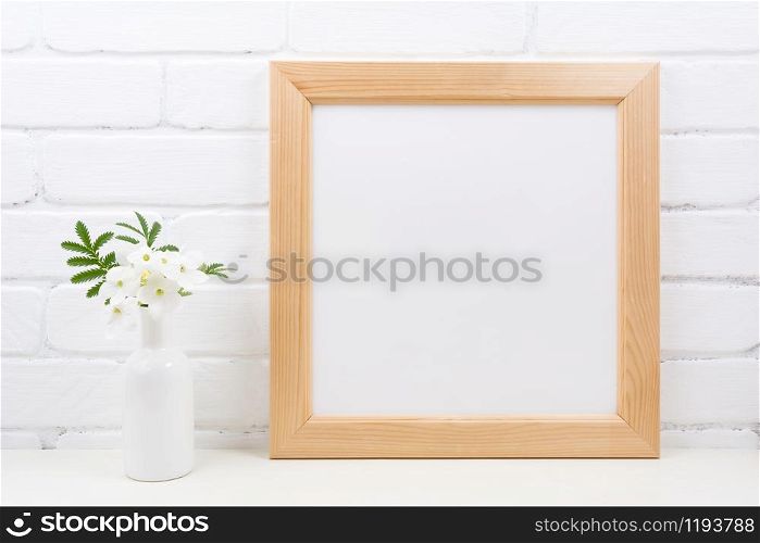Wooden square picture frame mockup with flowering white Tobacco plant. Empty frame mock up with Nicotiana flowers for presentation design. Template framing for modern art.