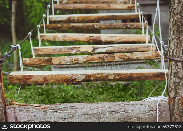 Wooden stairs in the green forest park. Wooden stairs in the green forest park with ropes