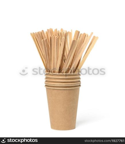wooden sticks for mixing liquid and empty brown paper disposable cups on a white background, concept eco-friendly, zero waste