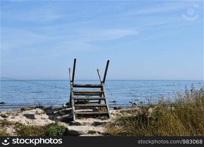 Wooden stile by a fence by the coast of the Baltic Sea at the island Oland