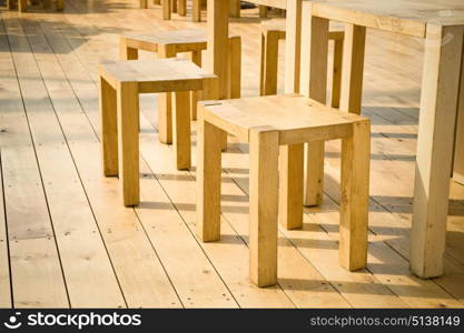 wooden stools and tables on decking floorboards