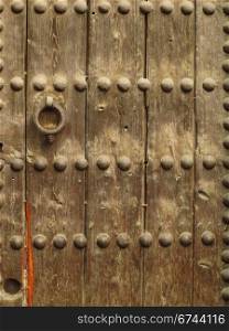 wooden surface of a door. Surface of a wooden door with nail heads