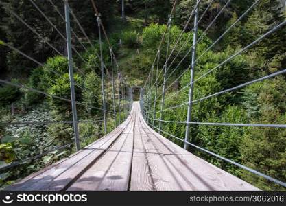 wooden suspension bridge in the forest beautiful mountain landscape in the summer. wooden suspension bridge in the forest beautiful mountain landscape