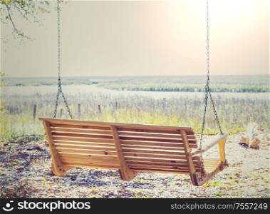 Wooden swing on the beach