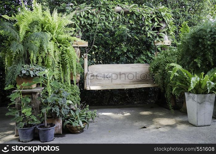 Wooden swing seat in outdoor garden, stock photo