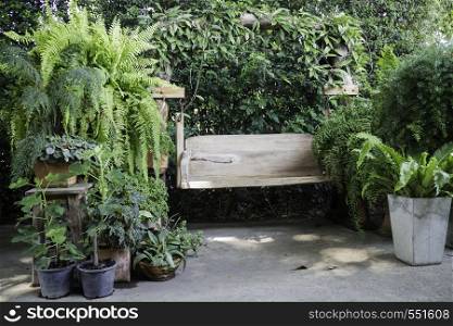 Wooden swing seat in outdoor garden, stock photo