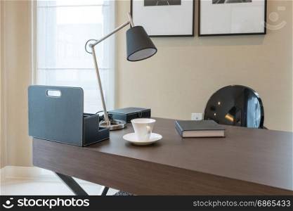 wooden table and books in modern working room interior