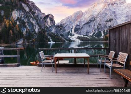 Wooden table and chairs on the Alpine mountain lake