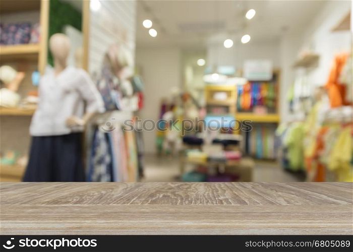 wooden table for display or montage your product with blur background of clothing selling in department store for use as shopping concept