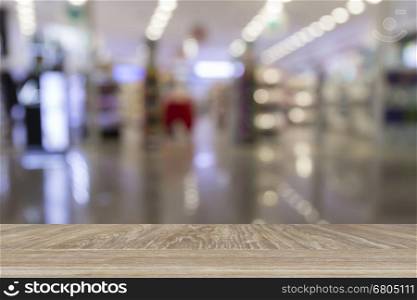 wooden table for display or montage your product with blur background of bokeh light of retail shop in department store