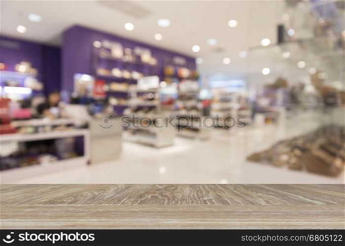wooden table for display or montage your product with blur background of shoes selling in department store for use as shopping concept