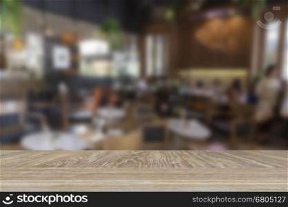 wooden table for display or montage your product with blur background of interior cafe coffee shop
