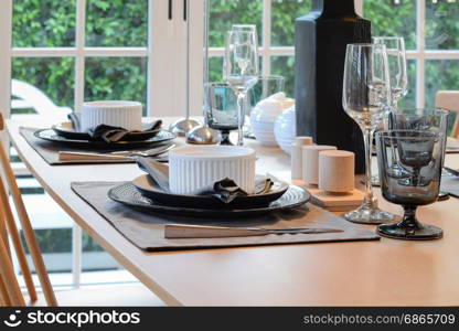 wooden table in dining room with elegant table setting