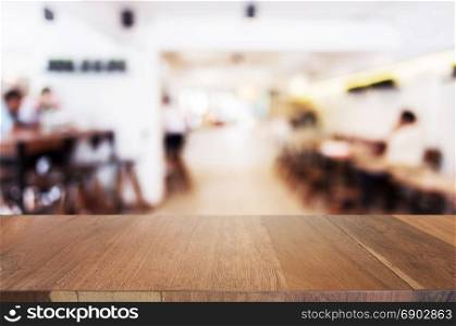 wooden table in front of blurred background of coffee shop cafe
