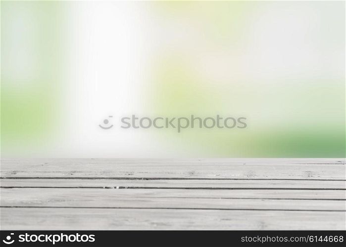 Wooden table in green nature in the spring