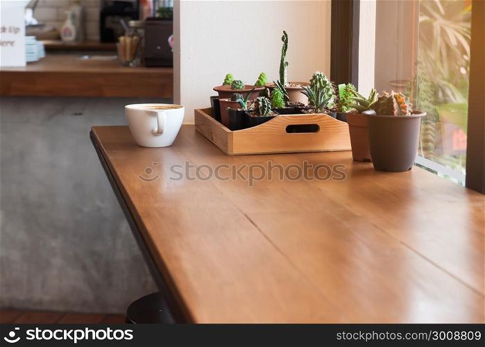 Wooden table near glass window in cafe, Interior design, Lifestyle