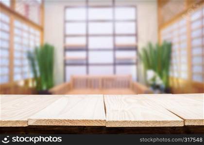 Wooden table on abstract blurred interior background and free space for your decoration display or montage your products.