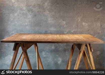 wooden table or tabletop near concrete wall background, place for work tools