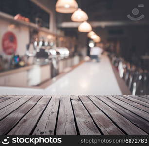 Wooden table top surface over blur cafe background