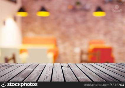 Wooden table top surface over blur kitchen cafe background
