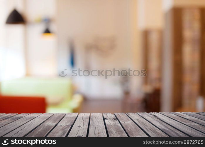 Wooden table top surface over blur kitchen cafe background