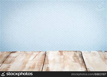 Wooden table top with blue wall background