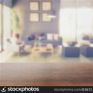 wooden table top with blur background of modern living room interior