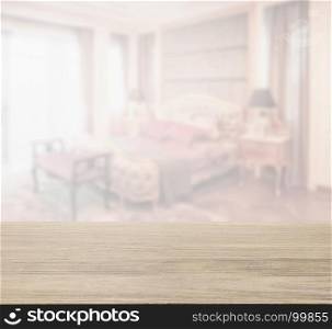 wooden table top with blur of bedroom in classic style interior