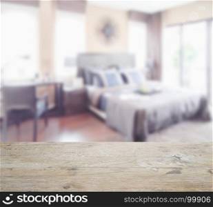 wooden table top with blur of classic style interior bedroom