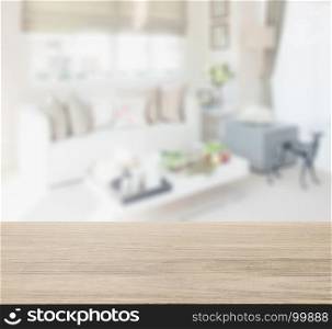 wooden table top with blur of living space interior